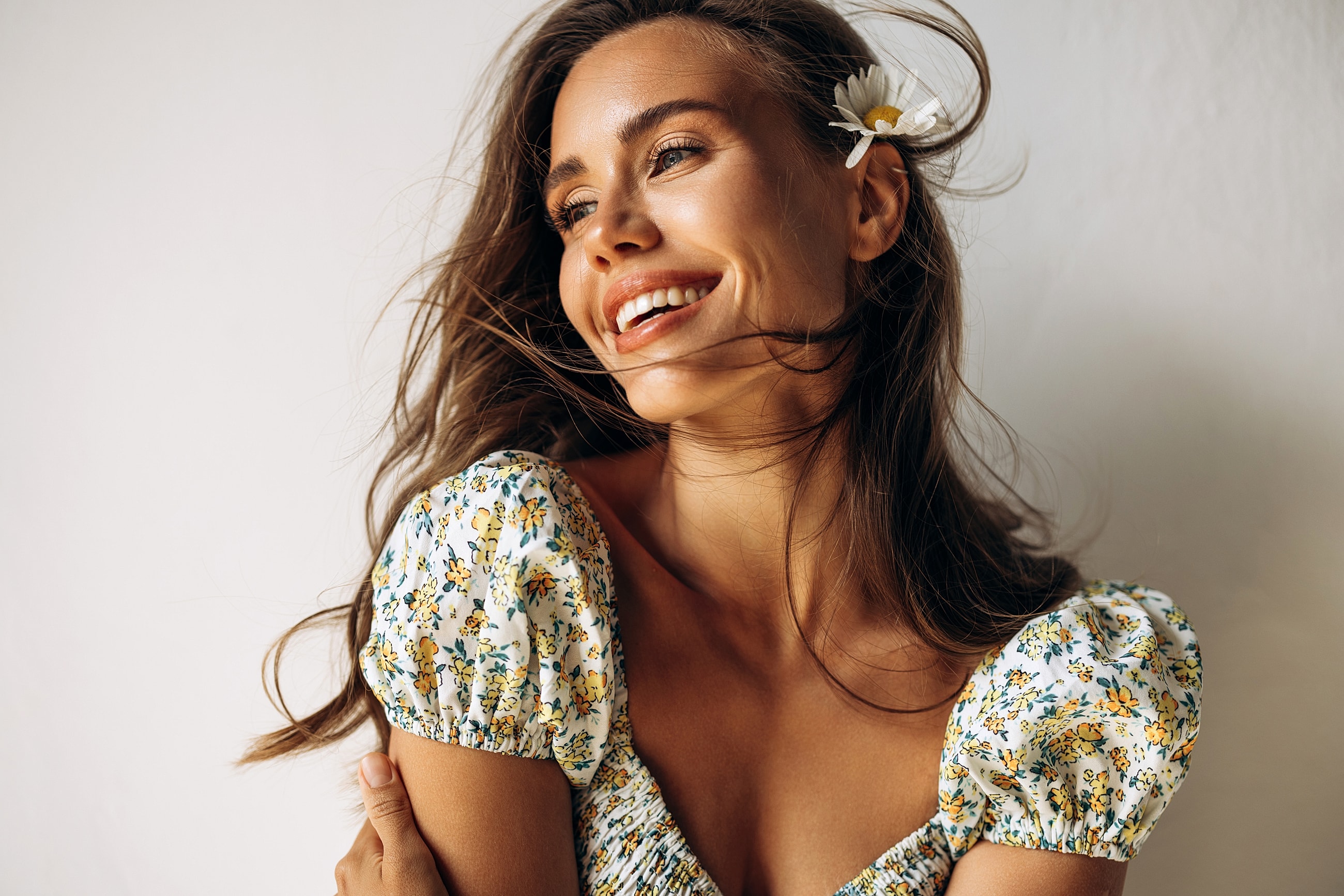 Smiling woman with flower in her hair.